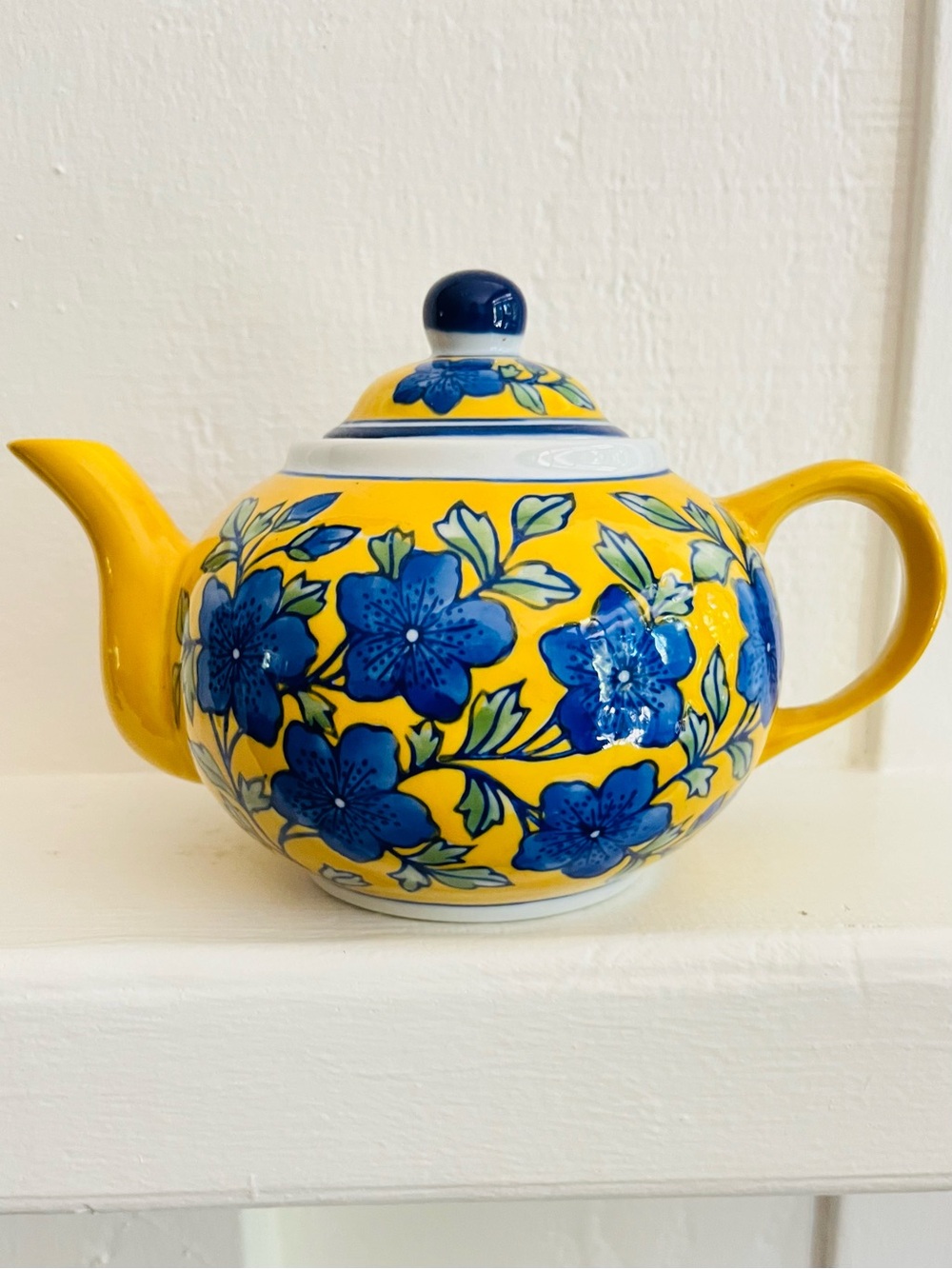 April Cornell vintage ceramic teapot. Vibrant yellow and blue floral design.